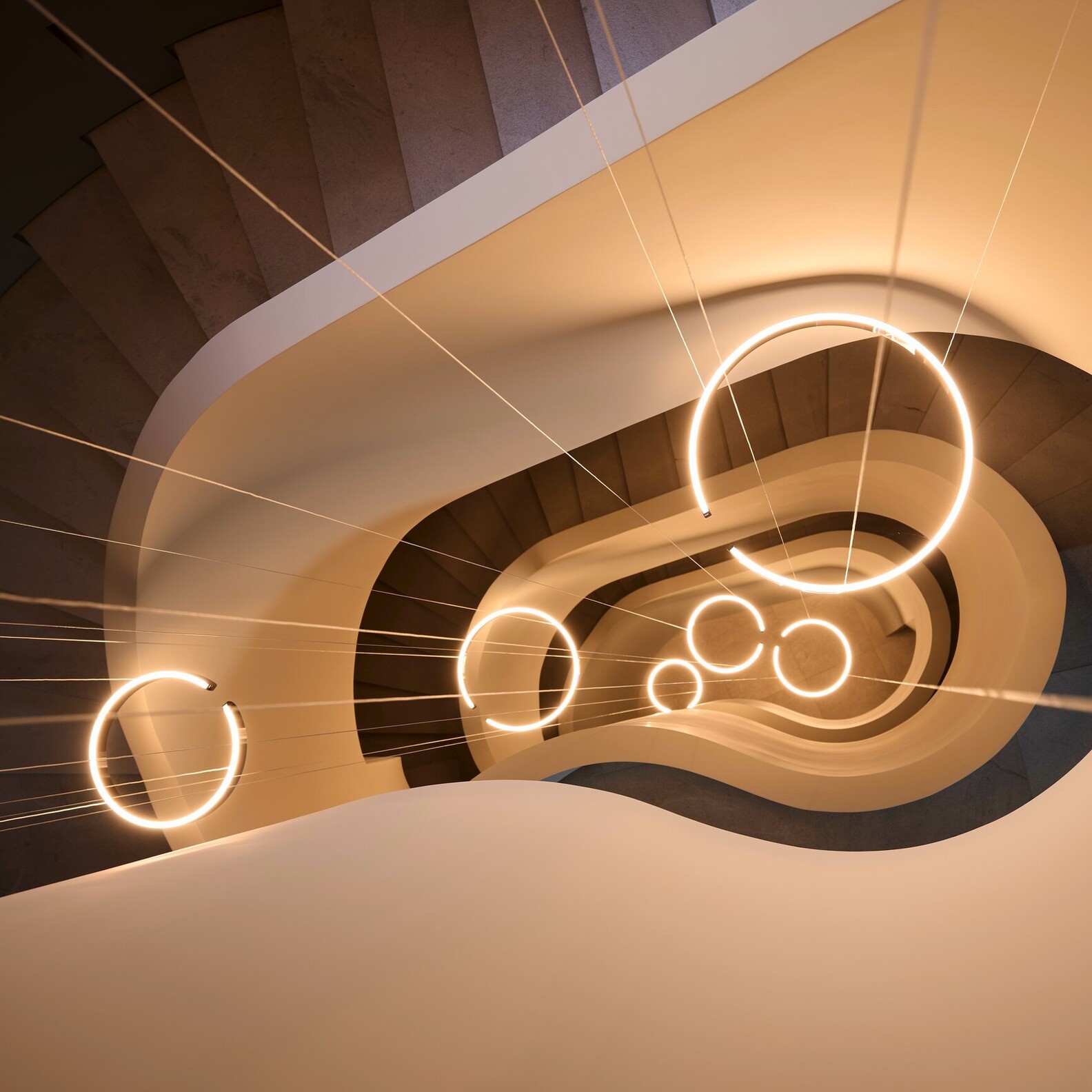 Occhio Mito soffitto ceiling luminaire in luxury staircase setting - grand architectural lighting for villas in Dubai