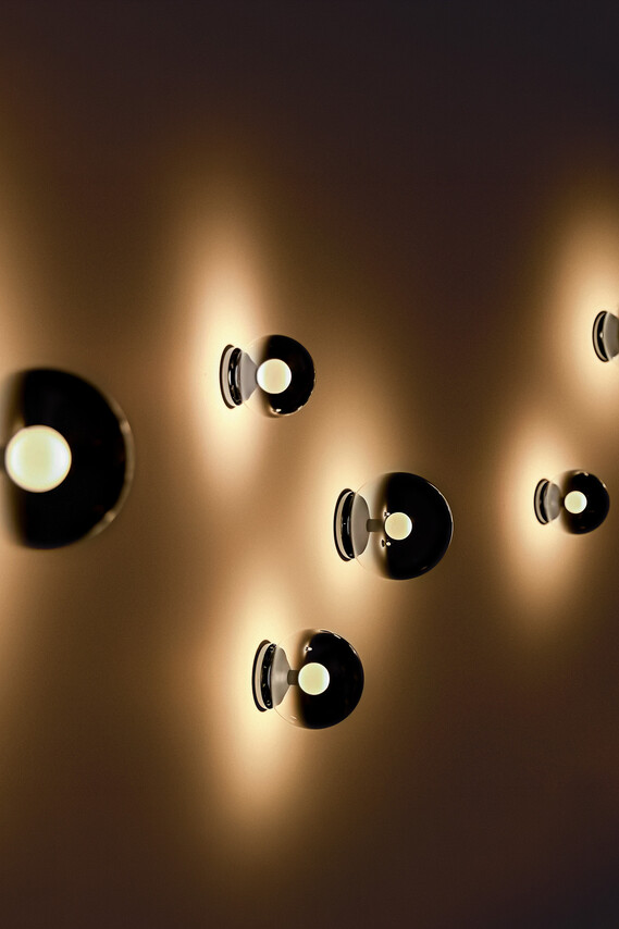 Occhio Luna scura wall luminaire on warm toned wall