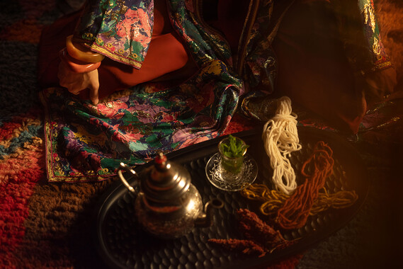 Tea and thread decoration laid flat on a presenter in warm surrounding