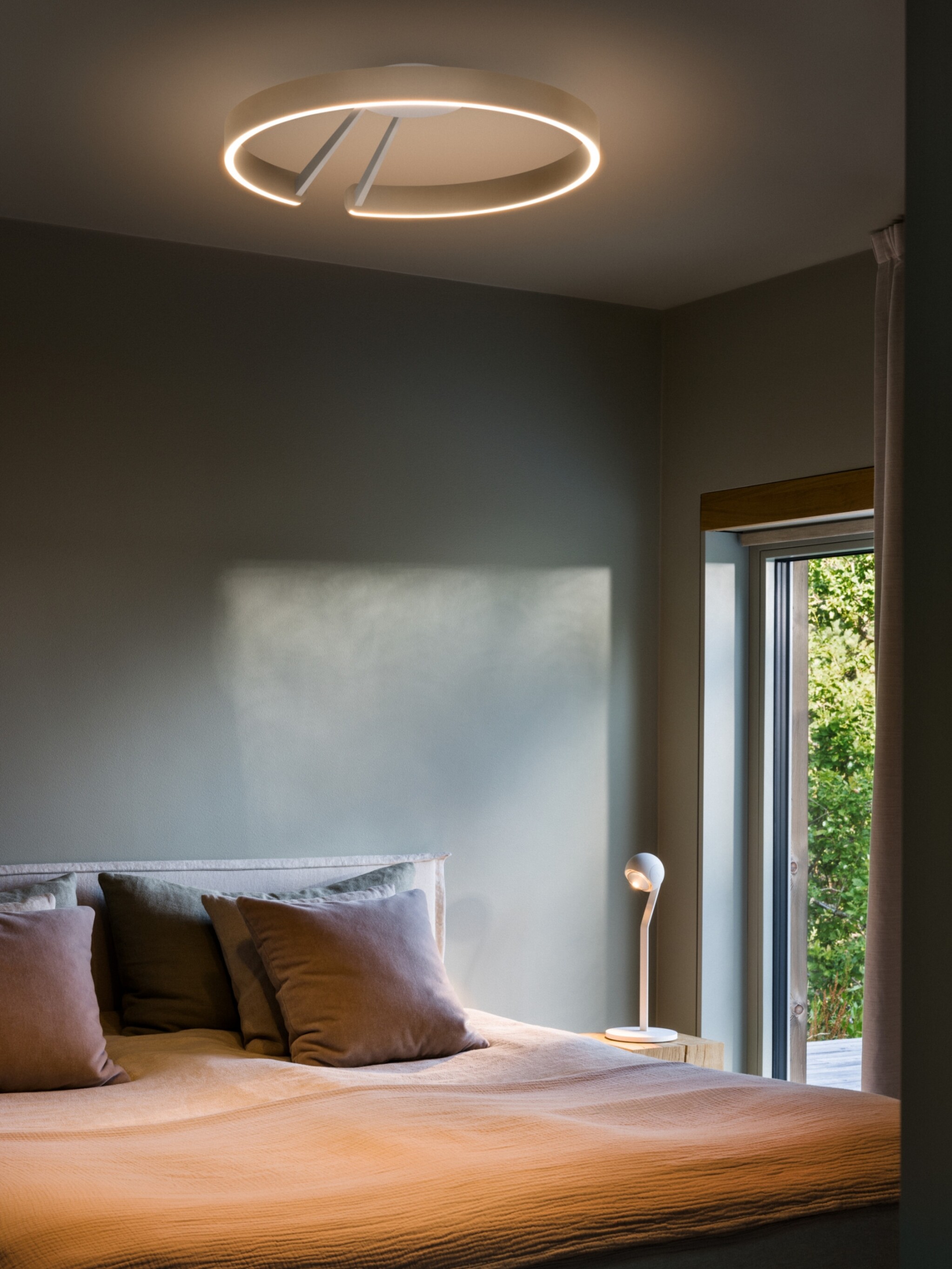 Mito aura ceiling luminaire creating soft halo in bedroom