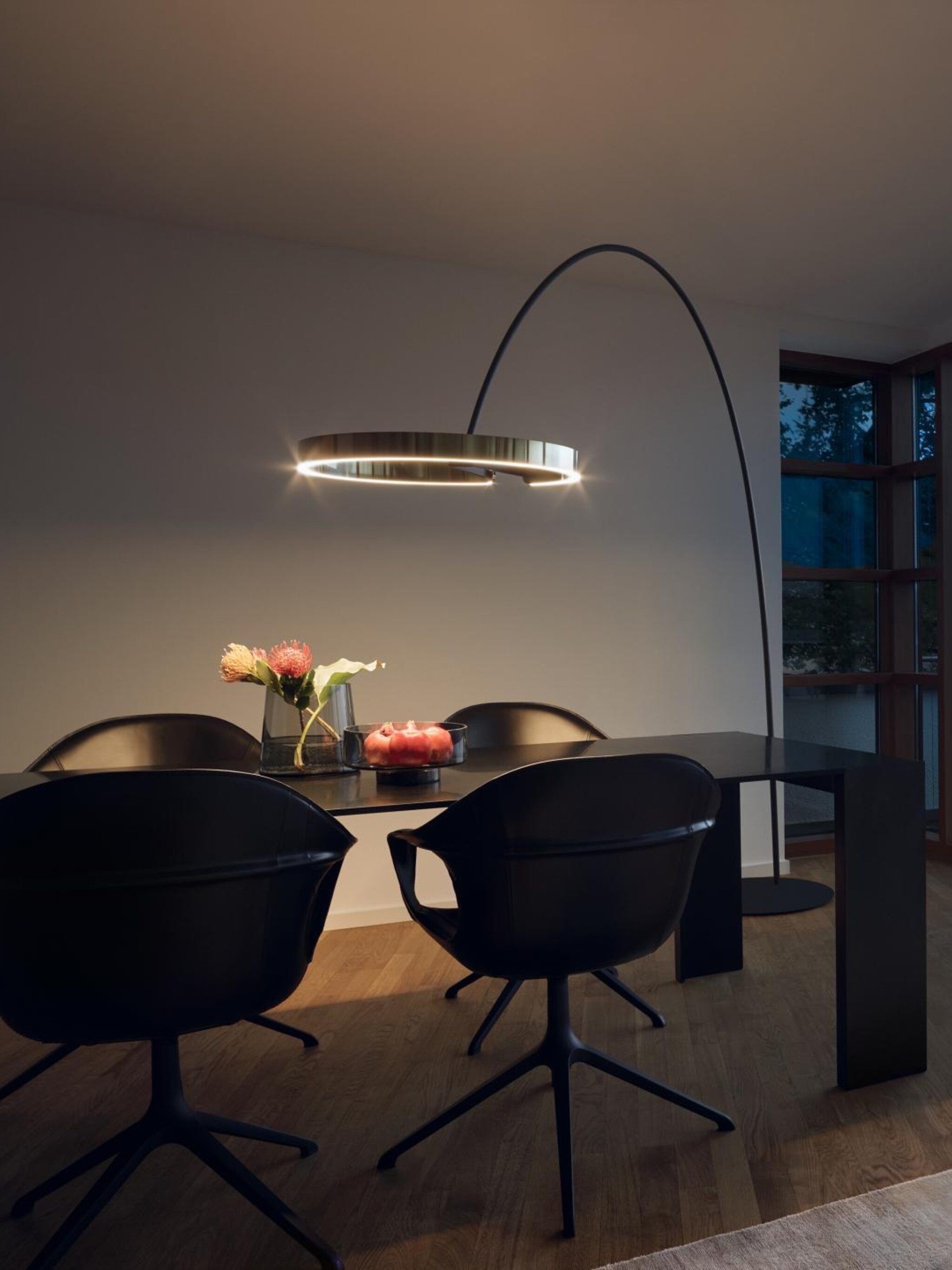 Mito largo arc luminaire above dining table