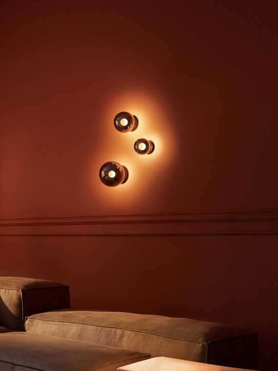 Occhio Luna scura wall luminaire on warm toned wall