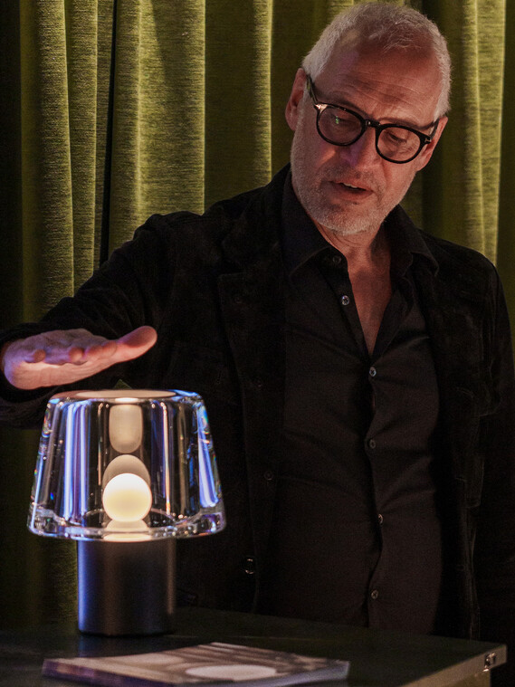 Milan Design Week Occhio Era pure cordless glass luminaire with people