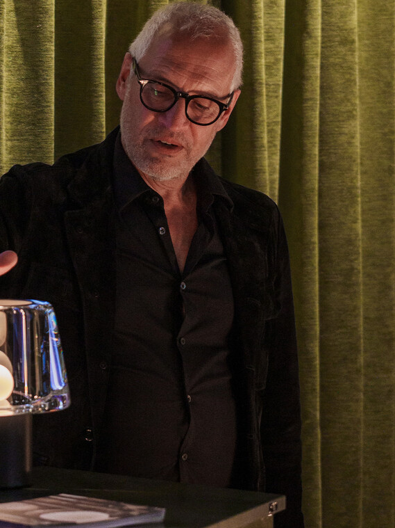 Milan Design Week Occhio Era pure cordless glass luminaire with people