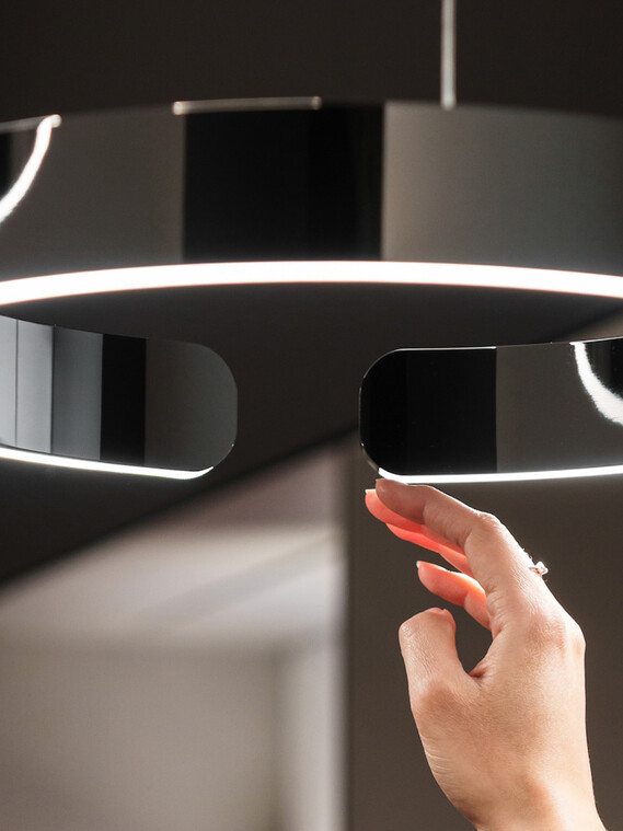 Milan Design Week Occhio mito sospeso dark chrome with hand
