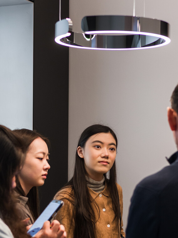 Milan Design Week Occhio Mito sospeso dark chrome with people