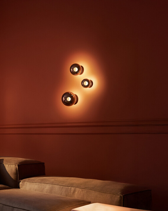 Occhio Luna scura wall luminaire on warm toned wall